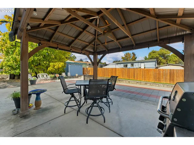 a view of an outdoor sitting area with furniture and umbrella