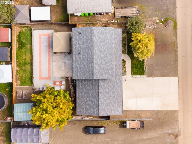 an aerial view of a house with a yard