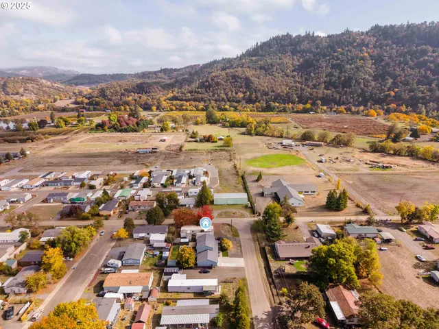 an aerial view of residential building with yard