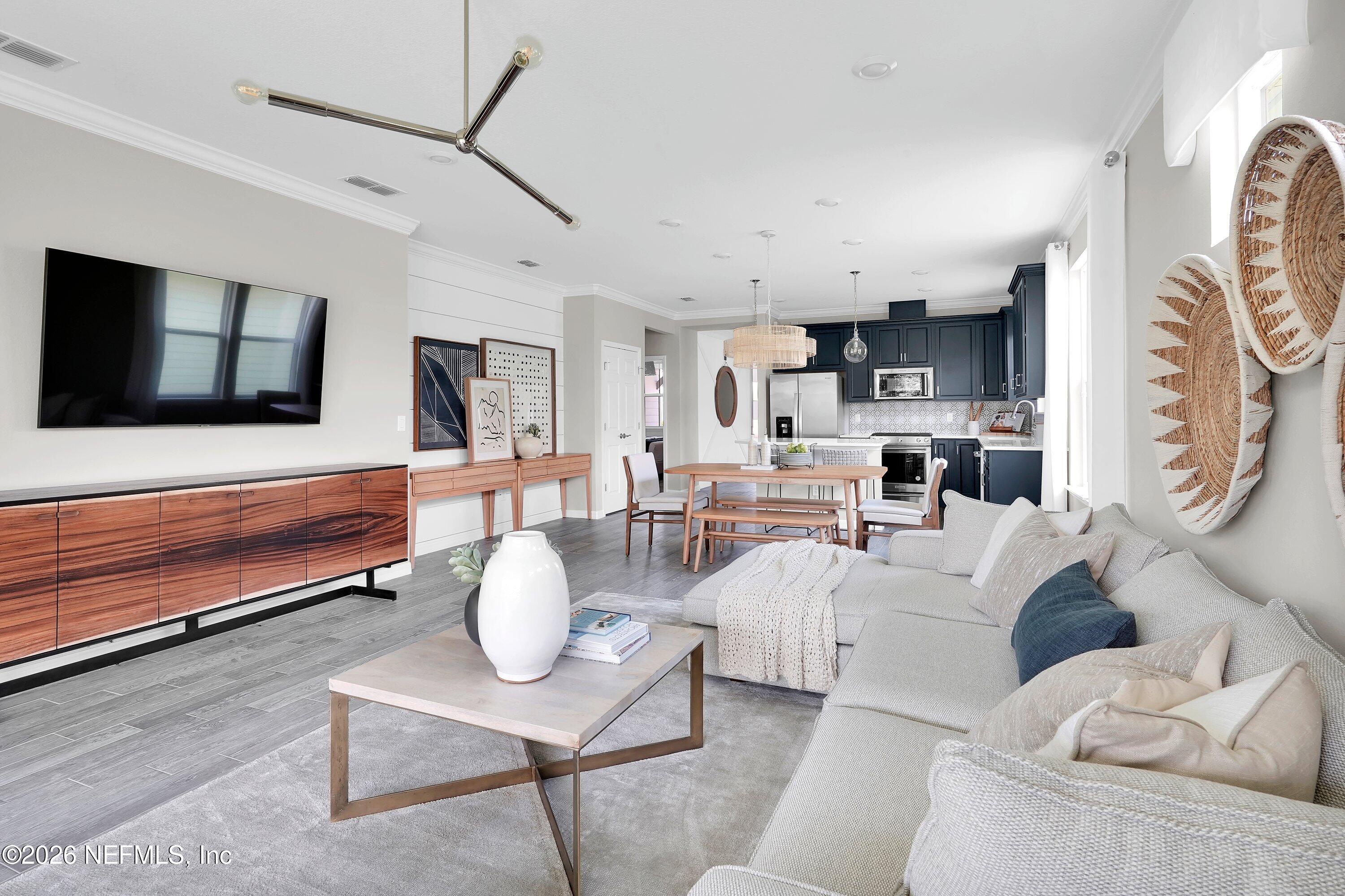328 Ecliptic Loop Yulee, FL 32097 - Photo 12 of 44 a living room with furniture and a flat screen tv