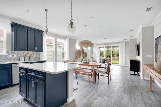 a kitchen with kitchen island granite countertop a sink stove and refrigerator