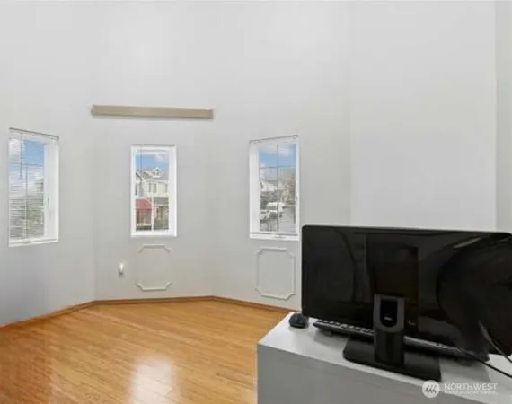 a living room with a bed furniture and a window