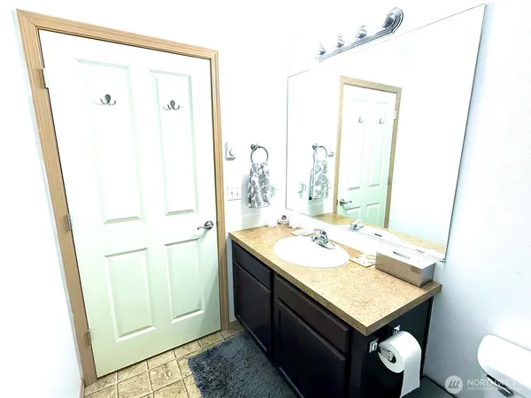 a bathroom with a sink vanity and a mirror