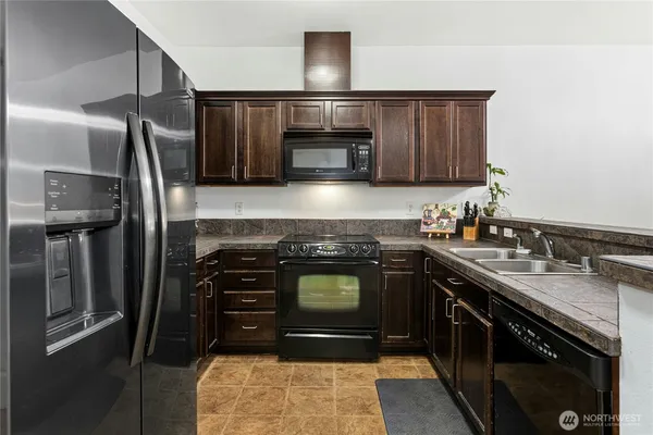 a kitchen with stainless steel appliances granite countertop a stove and a sink