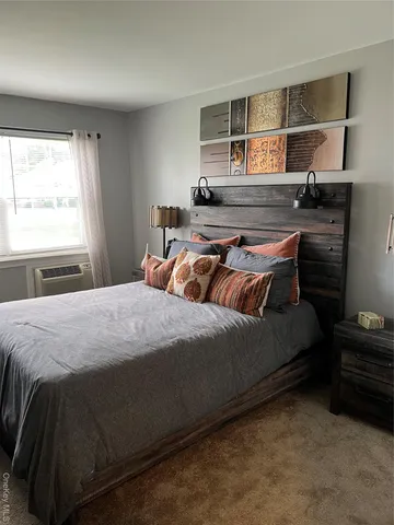 a bedroom with a bed and window