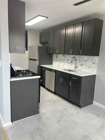 a kitchen with sink and cabinets