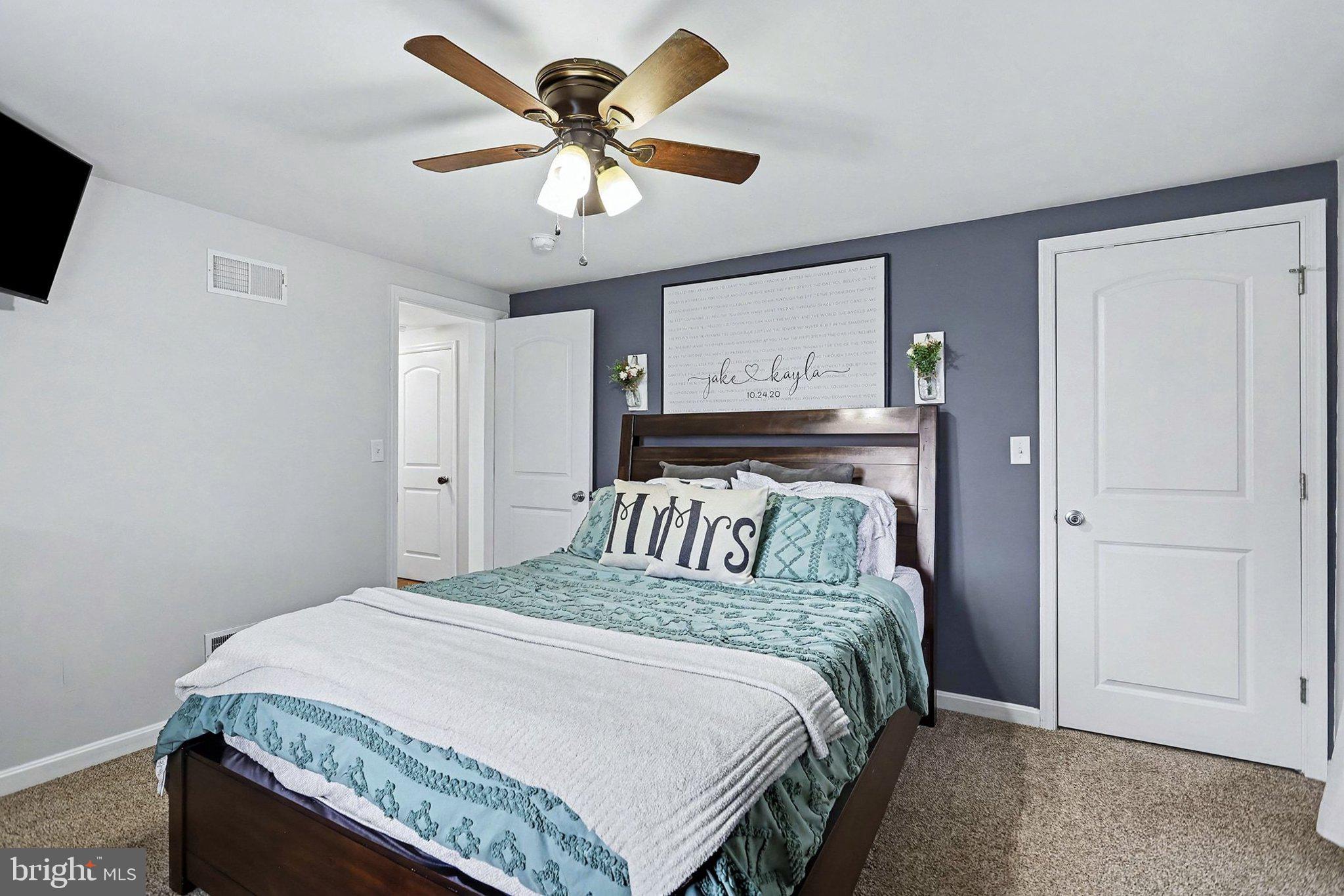 774 Fairview Drive Hanover, PA 17331 - Photo 12 of 32 a bedroom with a large bed and a chandelier