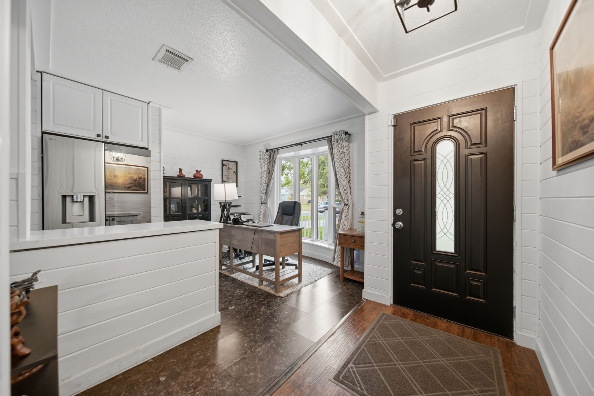 19519 Ricelake Lane Houston, TX 77084 - Photo 7 of 47 Beautiful entryway with elegant wood door and a cozy office nook, featuring large Bay windows that invite natural light and provide a view of the front yard.