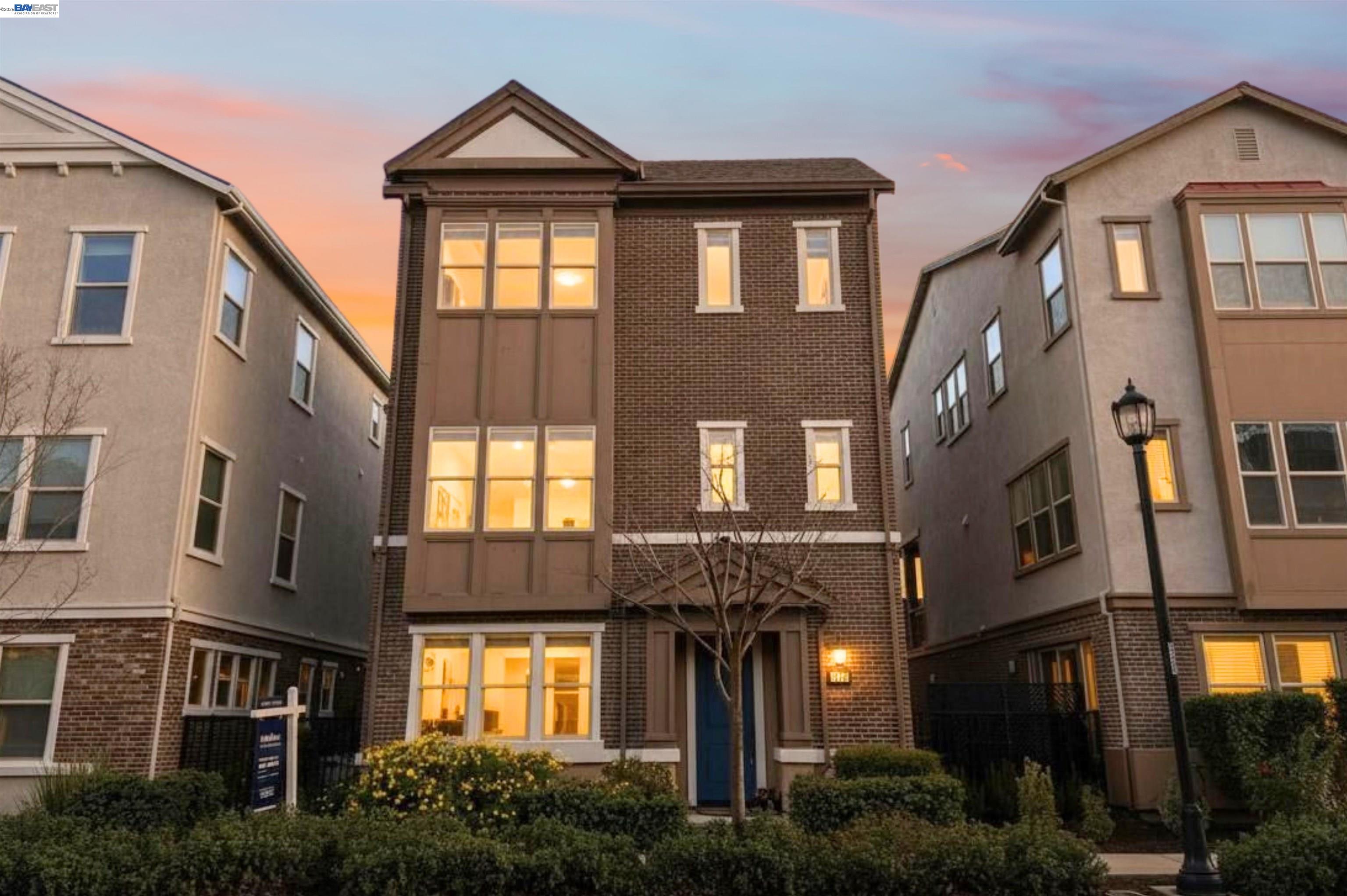 a front view of a residential apartment building with a yard