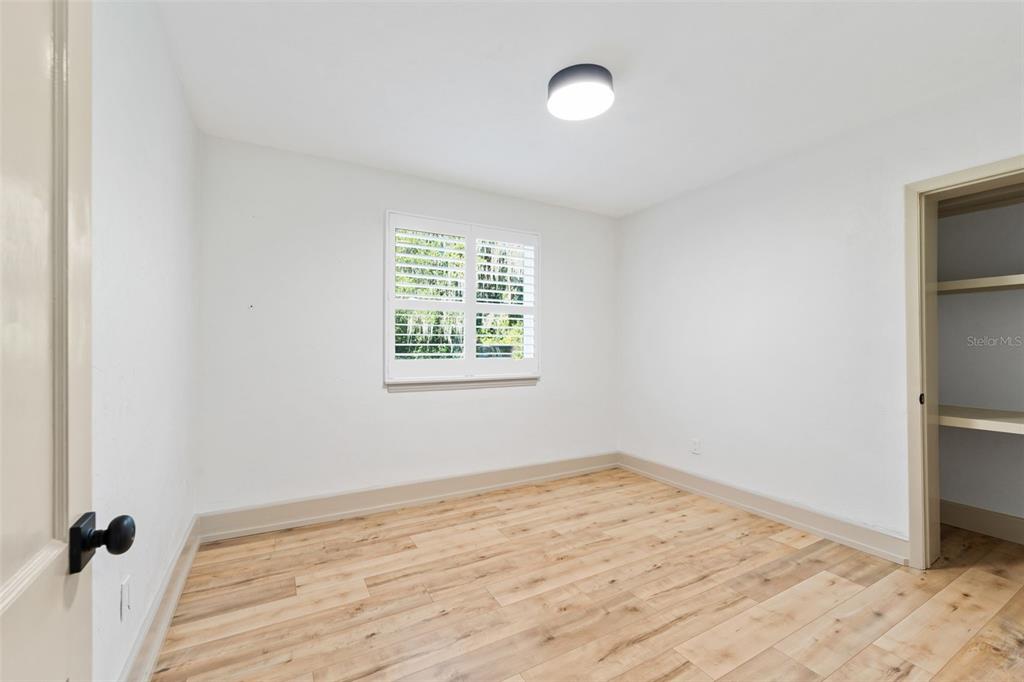 815 Northeast 12th Avenue Gainesville, FL 32601 - Photo 20 of 31 an empty room with a wooden floor and a window