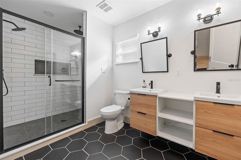 815 Northeast 12th Avenue Gainesville, FL 32601 - Photo 26 of 31 a bathroom with a double vanity sink mirror and toilet