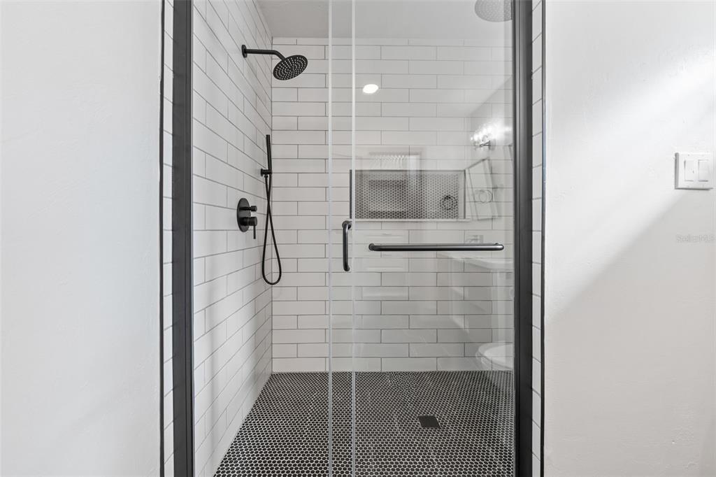 815 Northeast 12th Avenue Gainesville, FL 32601 - Photo 28 of 31 a bathroom with a glass shower door