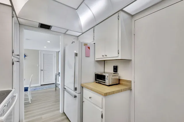 a kitchen with stainless steel appliances a stove refrigerator sink and cabinets