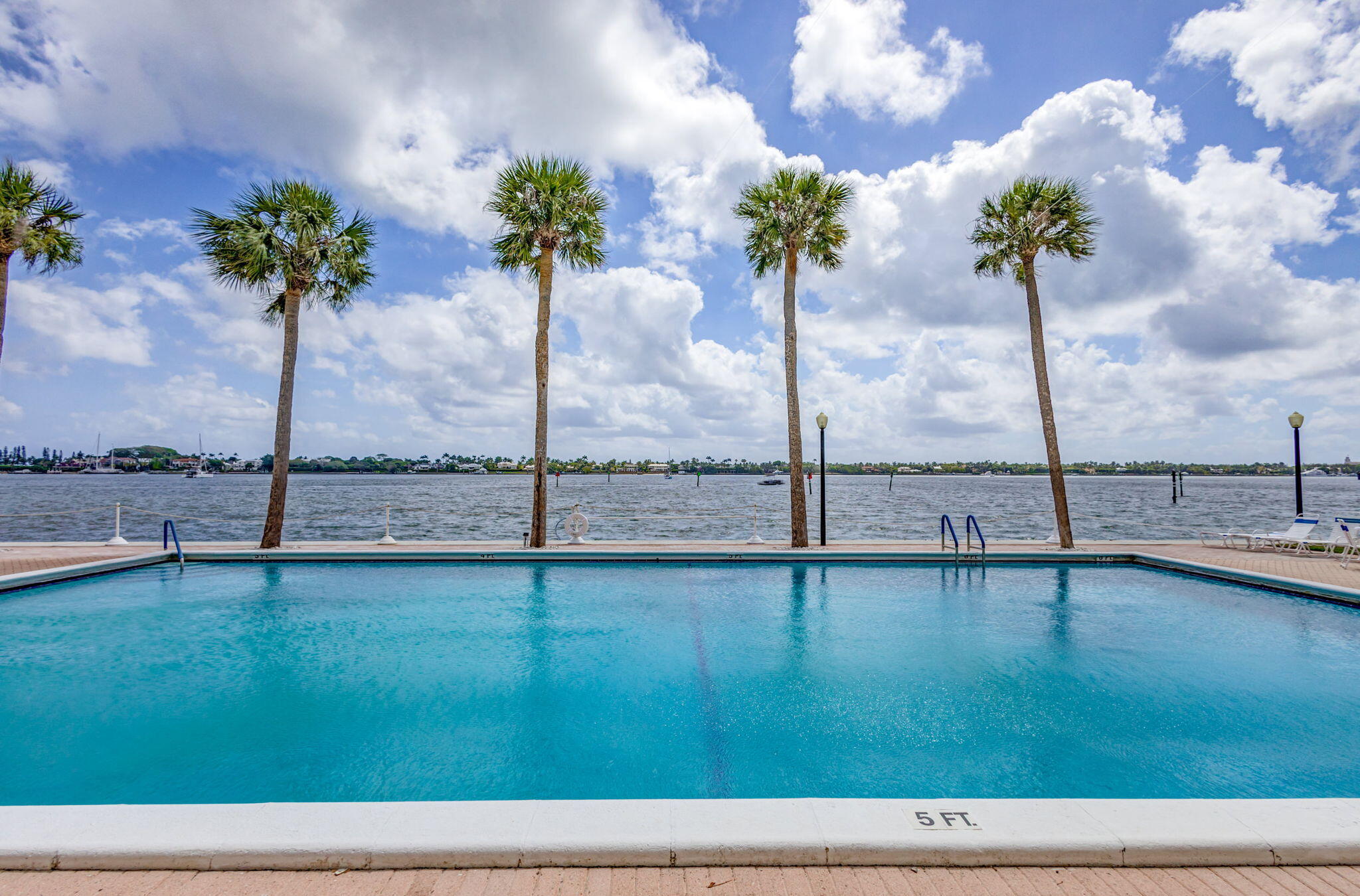 2600 North Flagler Drive, Unit 310 West Palm Beach, FL 33407 - Photo 2 of 42 a view of a lake with a floor to ceiling window and potted plants