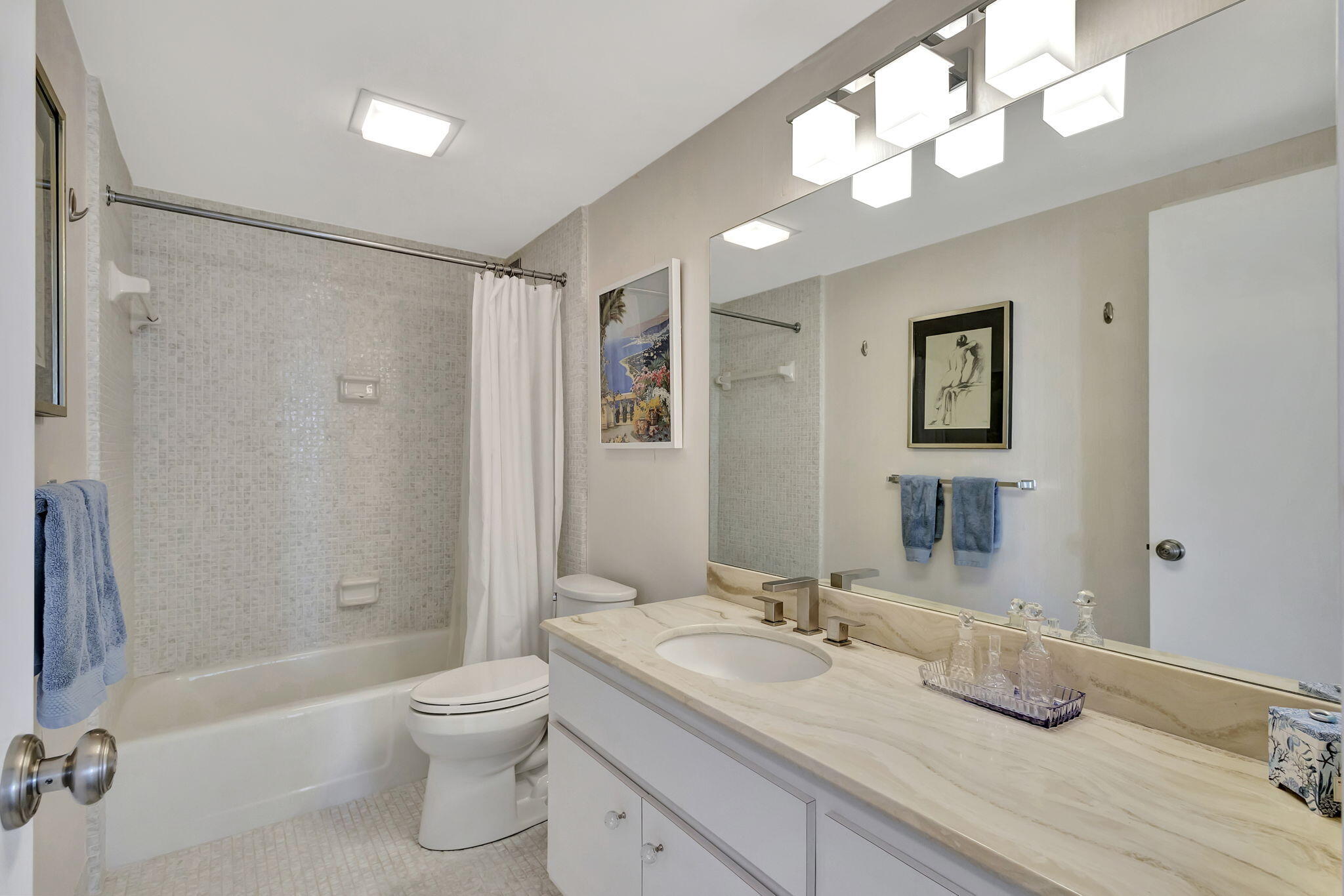 2600 North Flagler Drive, Unit 310 West Palm Beach, FL 33407 - Photo 24 of 42 a bathroom with a granite countertop sink a toilet and shower