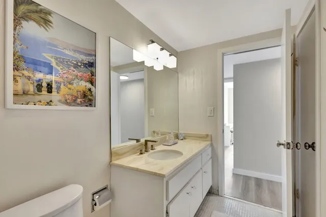 a bathroom with a sink toilet and a mirror