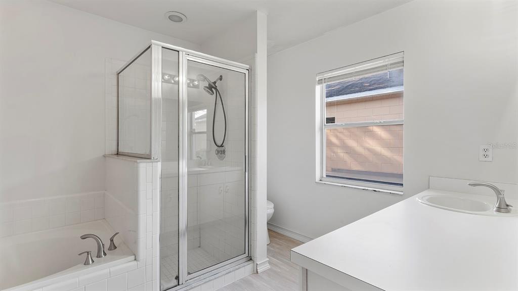 11029 Einbender Road Orlando, FL 32825 - Photo 12 of 27 a bathroom with a bathtub and a sink