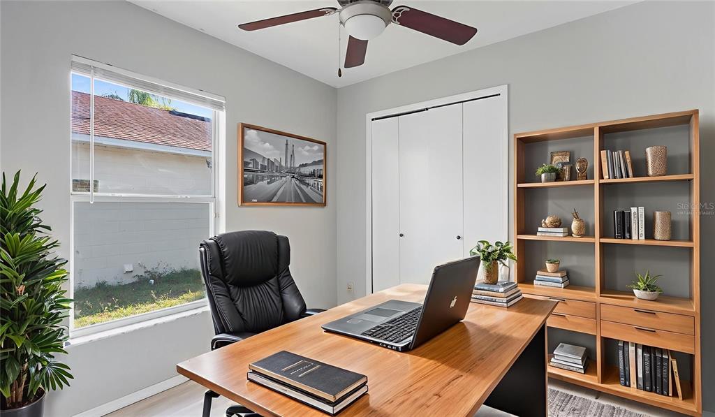 11029 Einbender Road Orlando, FL 32825 - Photo 13 of 27 a view of a workspace with furniture and a potted plant