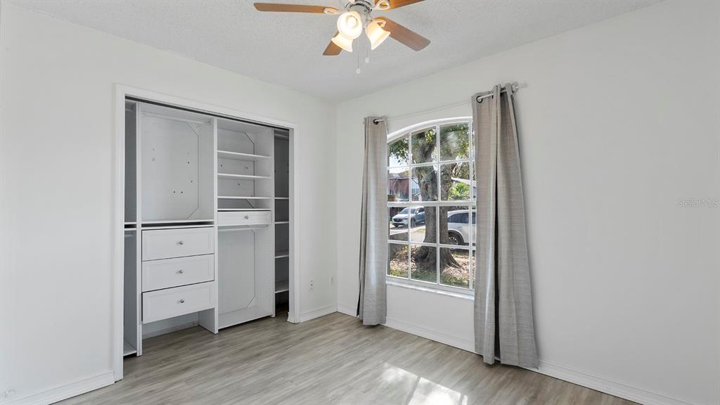 11029 Einbender Road Orlando, FL 32825 - Photo 15 of 27 wooden floor in an empty room with a window