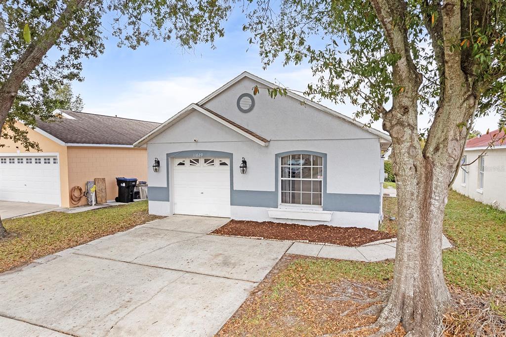 11029 Einbender Road Orlando, FL 32825 - Photo 27 of 27 a front view of a house with a yard and garage