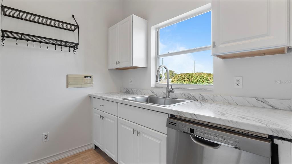 11029 Einbender Road Orlando, FL 32825 - Photo 6 of 27 a kitchen with a sink cabinets and window