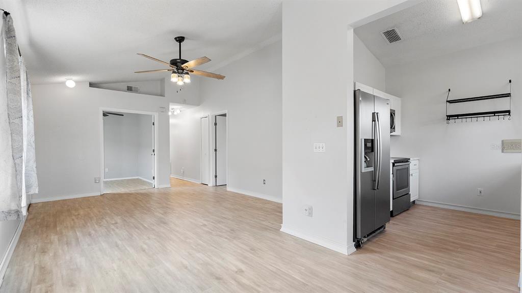 11029 Einbender Road Orlando, FL 32825 - Photo 8 of 27 a view of empty room with wooden floor and ceiling fan