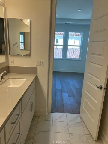 a bathroom with a sink a mirror and a toilet