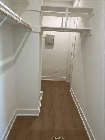 a view of walk in closet with empty racks
