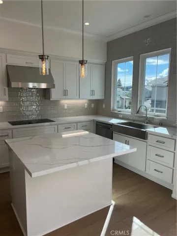 a kitchen with a sink a stove and cabinets