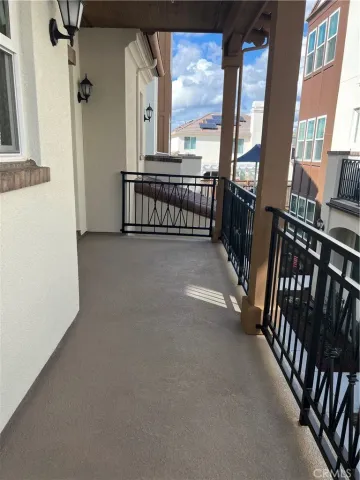 a view of a hallway with furniture and floor to ceiling window