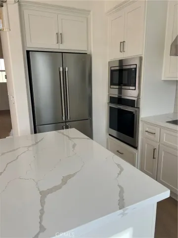 a close view of a refrigerator in kitchen and a sink