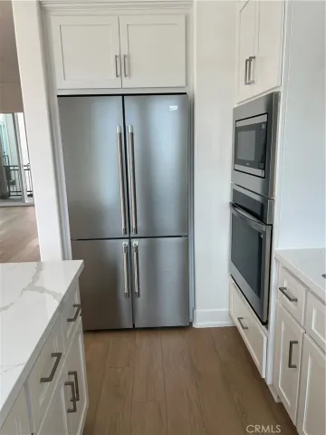 a kitchen with a refrigerator and a sink