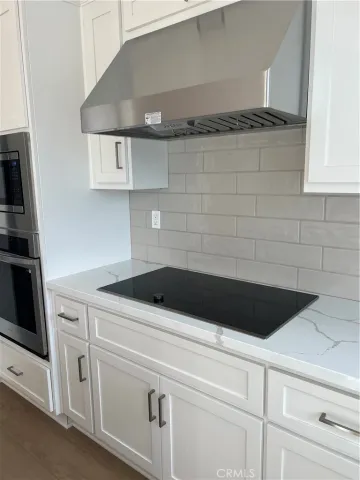 a close view of a stove a microwave and cabinets in the kitchen