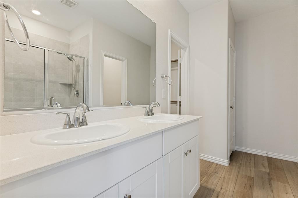 1237 Almond Road Azle, TX 76020 - Photo 12 of 24 a bathroom with a double vanity sink and a mirror