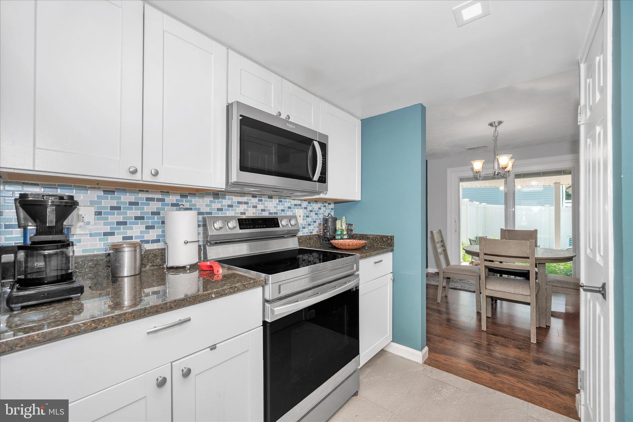 330 Heather Ridge Drive Frederick, MD 21702 - Photo 8 of 39 a kitchen with granite countertop a stove a sink and a microwave