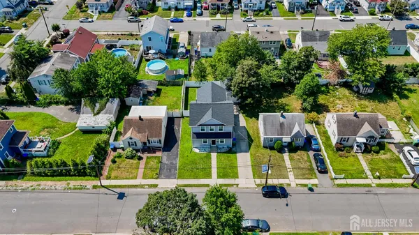 an aerial view of multiple houses with yard