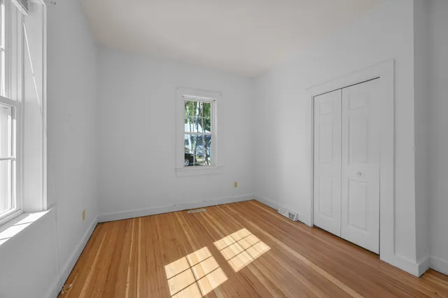 a view of a room with wooden floor and natural light