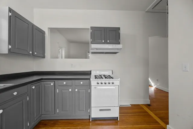 a kitchen with stainless steel appliances granite countertop a sink and cabinets