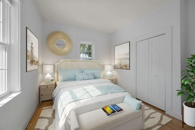 a bedroom with a bed and a potted plant