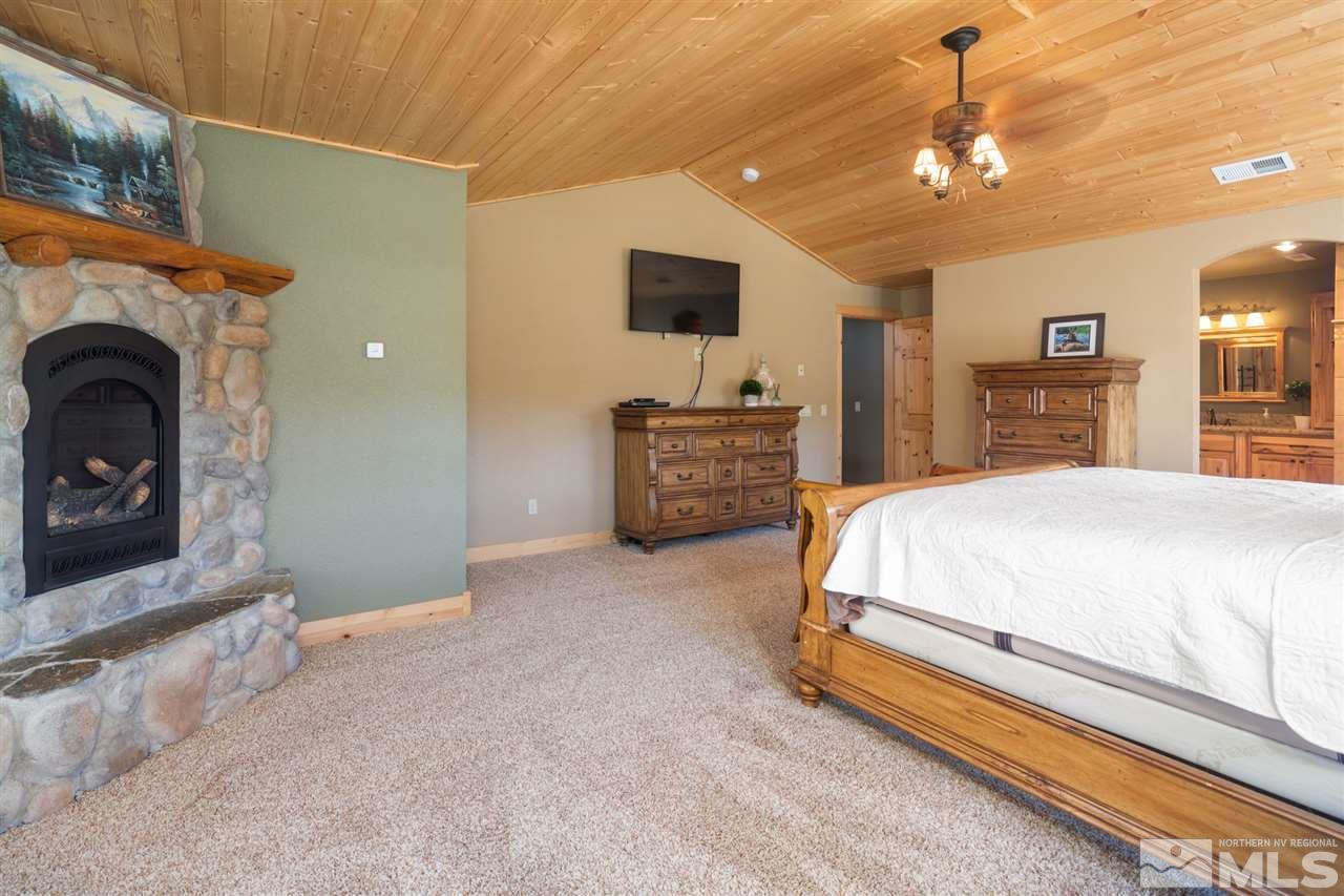 345 Prickly Pear Road Verdi, NV 89439 - Photo 17 of 26 a spacious bedroom with a bed and a television