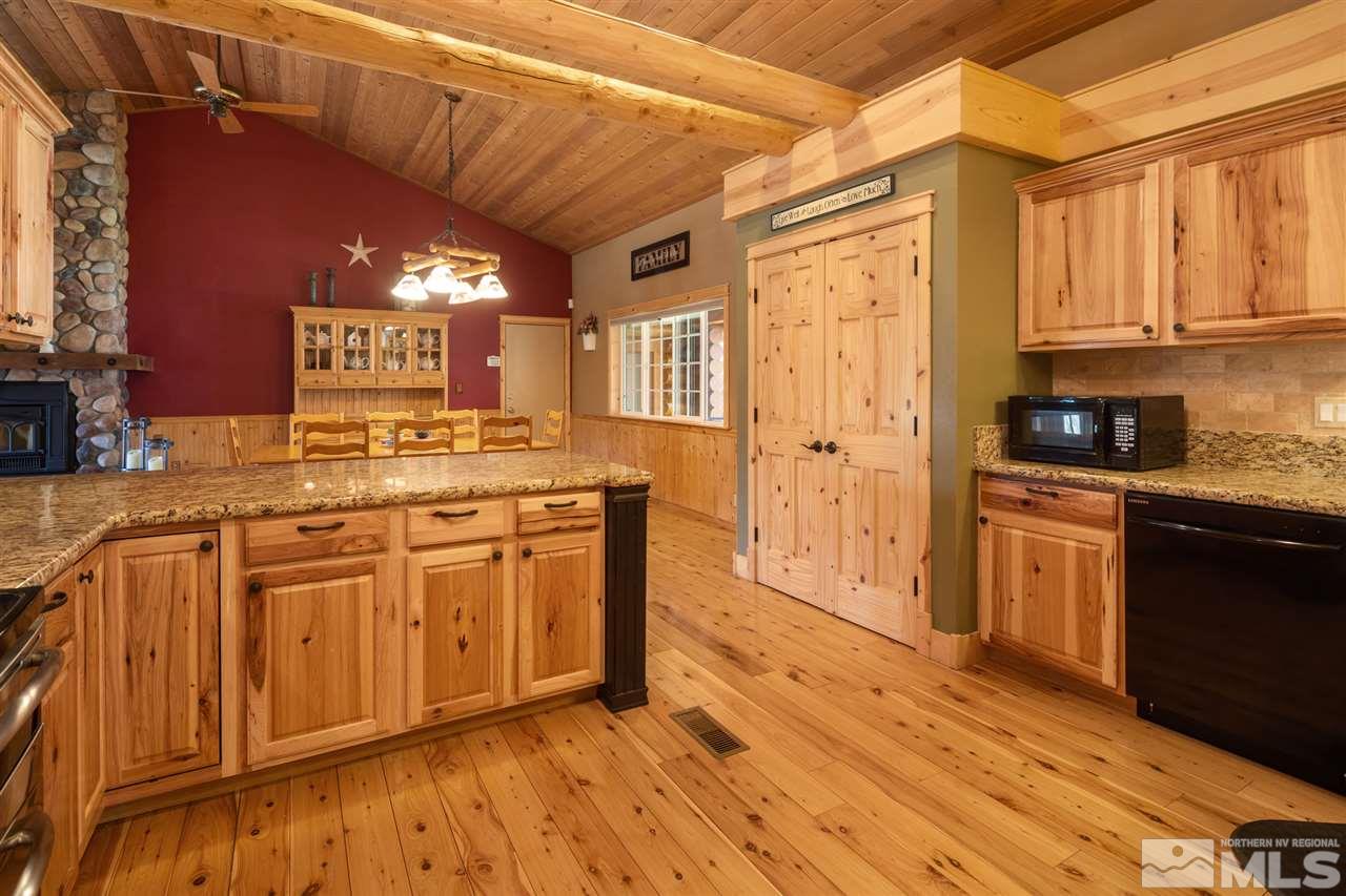 345 Prickly Pear Road Verdi, NV 89439 - Photo 6 of 26 a kitchen with stainless steel appliances granite countertop a stove a sink dishwasher and a refrigerator with wooden cabinets