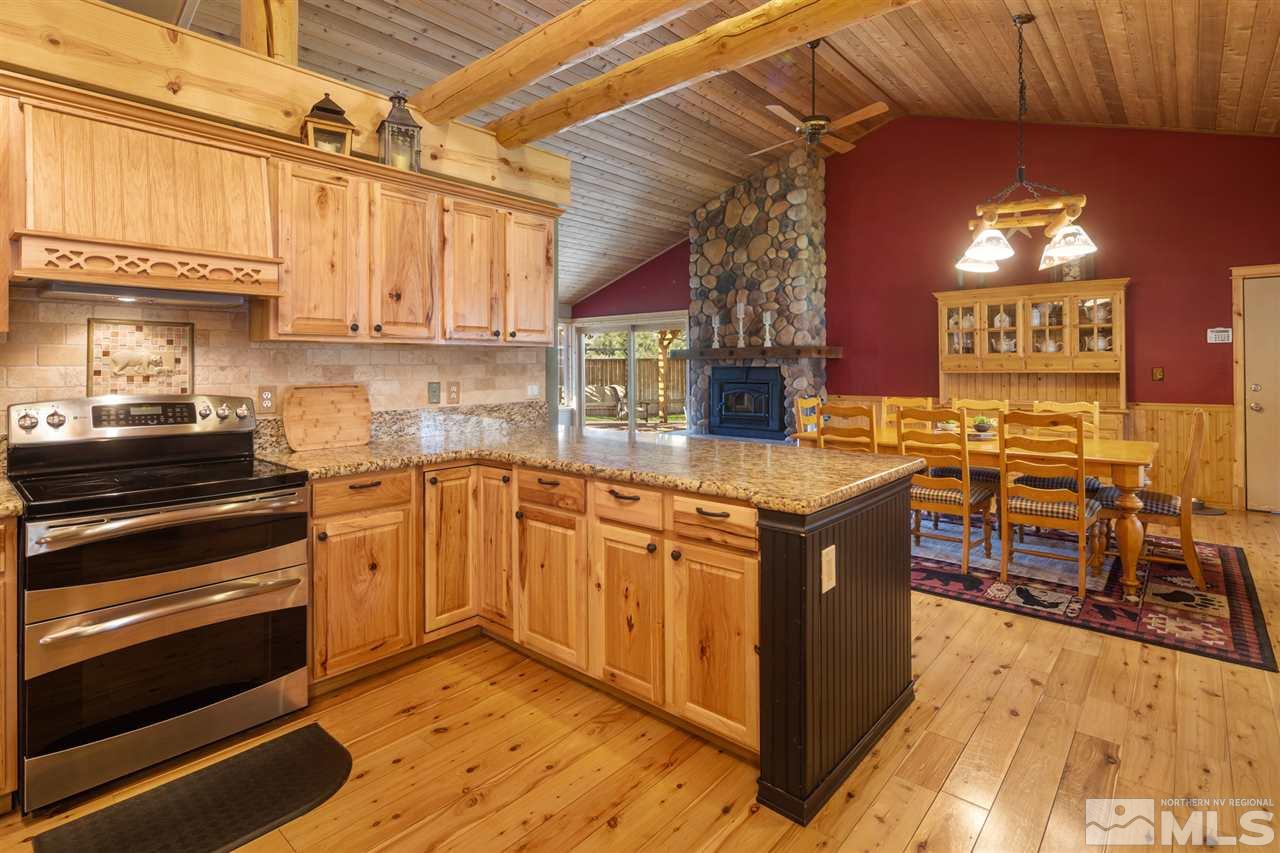 345 Prickly Pear Road Verdi, NV 89439 - Photo 7 of 26 a kitchen with stainless steel appliances granite countertop a stove a sink and a microwave