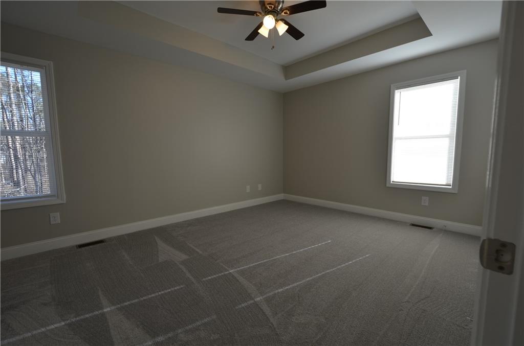 112 Jade Lane Dallas, GA 30132 - Photo 13 of 27 an empty room with a window and a fan