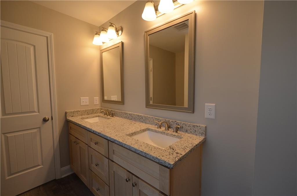 112 Jade Lane Dallas, GA 30132 - Photo 16 of 27 a bathroom with a granite countertop sink and a mirror