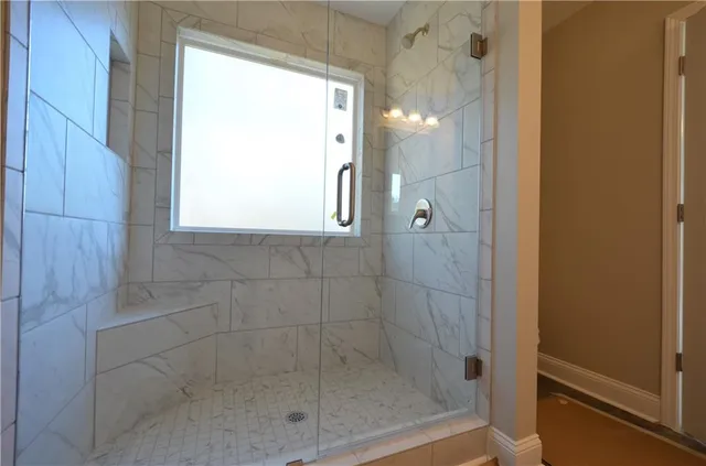 a bathroom with a granite countertop sink a toilet and shower