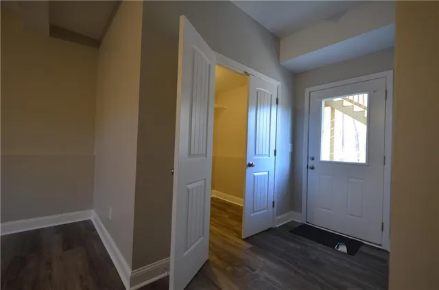 a bathroom with a granite countertop toilet and a shower