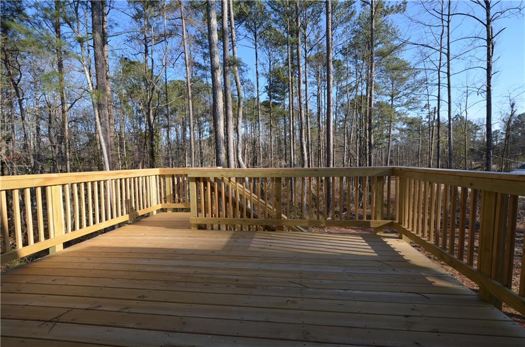 112 Jade Lane Dallas, GA 30132 - Photo 25 of 27 a view of a roof deck with wooden fence and floor