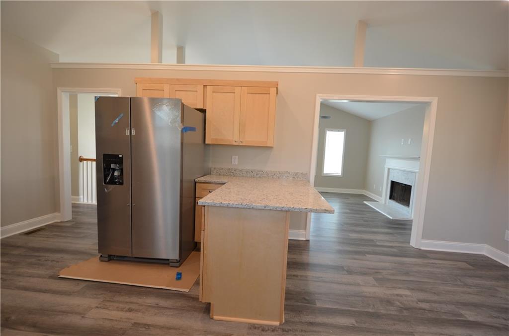 112 Jade Lane Dallas, GA 30132 - Photo 7 of 27 a view of kitchen with refrigerator and wooden floor