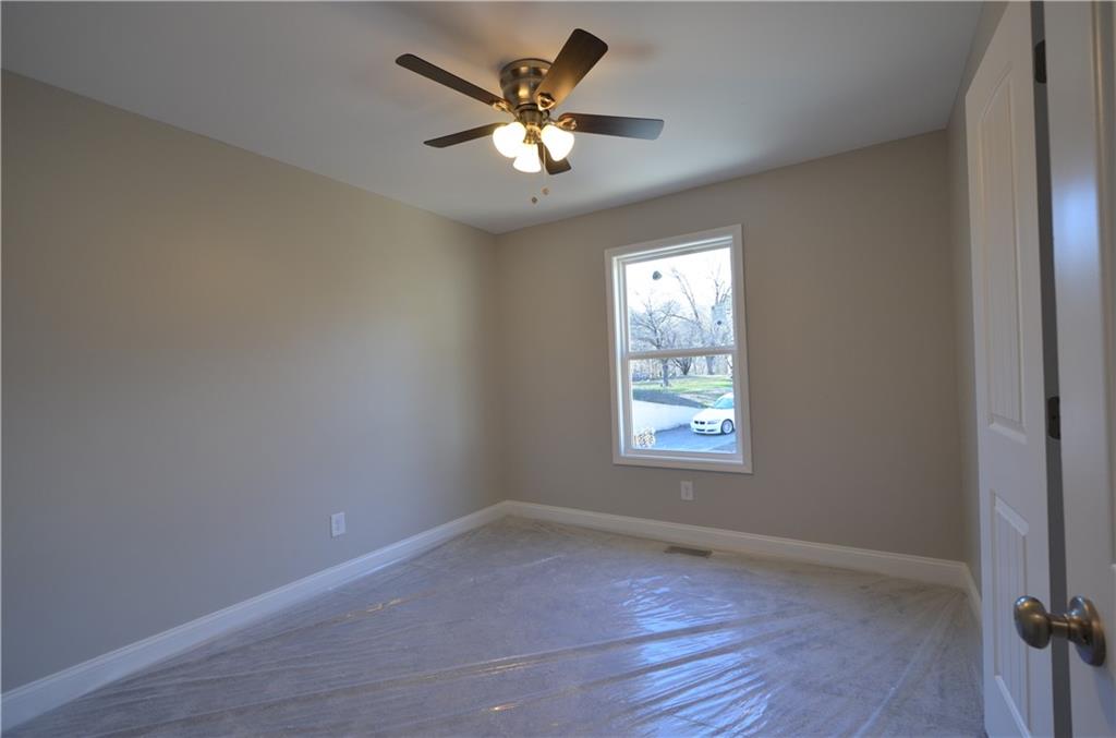 112 Jade Lane Dallas, GA 30132 - Photo 10 of 27 an empty room with wooden floor and windows