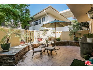 281 South Barrington Avenue, Unit C2 Los Angeles, CA 90049 - Photo 1 of 24 a view of a backyard with furniture and a table